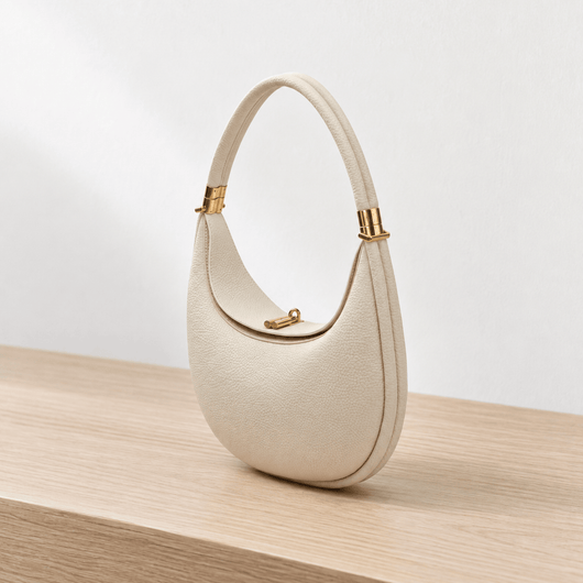 The Sunday Avenue Celeste Cream Pebbled Leather Crescent Shoulder Bag