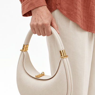 The Sunday Avenue Celeste Cream Pebbled Leather Crescent Shoulder Bag